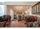 Elegant dining area with stylish chandelier, seating, and seamless access to the living room at 4695 Shireton Ct, Indianapolis, IN 46254