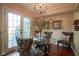 Charming dining area with a glass table, stylish chairs, and natural light from the glass doors at 4695 Shireton Ct, Indianapolis, IN 46254