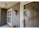 Inviting front door and exterior details, complemented by a decorative wreath and stylish lighting at 4695 Shireton Ct, Indianapolis, IN 46254