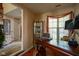 Inviting home office features a wooden desk, decorative cabinet, and light-filled window for a productive workspace at 4695 Shireton Ct, Indianapolis, IN 46254