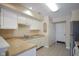 Kitchen with white cabinets, double sink, and tile floors at 4695 Shireton Ct, Indianapolis, IN 46254
