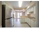 Open kitchen with white cabinets, stainless steel appliances, and view of dining area at 4695 Shireton Ct, Indianapolis, IN 46254