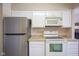 Kitchen features white cabinets, stainless steel appliances, and a tile backsplash at 4695 Shireton Ct, Indianapolis, IN 46254