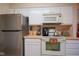 Kitchen featuring stainless steel appliances, white cabinets, and light countertops at 4695 Shireton Ct, Indianapolis, IN 46254