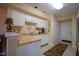 Functional kitchen with white cabinetry, tile flooring, and ample counter space for meal preparation at 4695 Shireton Ct, Indianapolis, IN 46254