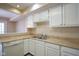 Kitchen boasts white cabinets, double sink, and tile flooring at 4695 Shireton Ct, Indianapolis, IN 46254