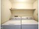 Laundry room with washer, dryer, and overhead shelving at 4695 Shireton Ct, Indianapolis, IN 46254