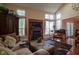 Comfortable living room with fireplace, ample seating, and natural light from multiple windows at 4695 Shireton Ct, Indianapolis, IN 46254