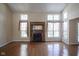 Living room with hardwood floors, large windows, and a fireplace at 4695 Shireton Ct, Indianapolis, IN 46254