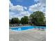 Inviting community pool with lounge chairs and mature trees under a beautiful sky at 4695 Shireton Ct, Indianapolis, IN 46254