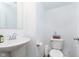 Half bathroom with white fixtures, geometric accent wall, and modern design at 1130 Cobra Dr, Franklin, IN 46131