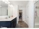 Bathroom featuring double sinks, dark cabinets, and a glass-enclosed shower and closet at 1130 Cobra Dr, Franklin, IN 46131