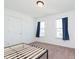 Bright bedroom featuring neutral walls, carpeting, two windows with blue curtains and a minimalist bed frame at 1130 Cobra Dr, Franklin, IN 46131