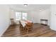 Inviting dining room with hardwood floors, a table with seating for six, and a view of the front yard at 1130 Cobra Dr, Franklin, IN 46131