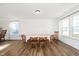 Bright dining area featuring wood floors, a table set for six, and plenty of natural light at 1130 Cobra Dr, Franklin, IN 46131