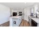 Modern kitchen featuring gray cabinets, stainless steel appliances, and a center island with stone countertop at 1130 Cobra Dr, Franklin, IN 46131