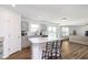 Kitchen leading to an open-plan living room and bar seating, with white countertops and gray cabinets at 1130 Cobra Dr, Franklin, IN 46131