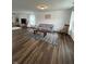 Spacious living room with wood-look floors, lots of natural light, and a calming color palette at 1130 Cobra Dr, Franklin, IN 46131