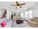 Spacious living room with a ceiling fan, comfortable sofas, and access to the kitchen at 1130 Cobra Dr, Franklin, IN 46131