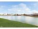 Picturesque view of the neighborhood lake framed by lush green grass and a clear, blue sky filled with clouds at 1130 Cobra Dr, Franklin, IN 46131