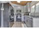 Modern kitchen with gray cabinets, granite countertops, and black appliances at 7438 Haw Dr, Nineveh, IN 46164