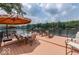 Large lakefront deck with umbrella, seating, and stunning lake views at 7438 Haw Dr, Nineveh, IN 46164
