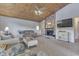 Living room with vaulted wood ceiling, fireplace, and comfy furniture at 7438 Haw Dr, Nineveh, IN 46164