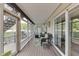 Lovely screened porch with wicker furniture and lake views at 7438 Haw Dr, Nineveh, IN 46164