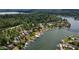 Beautiful aerial view of waterfront homes surrounded by lush trees and blue water on a sunny day at 4161 S Summit Ln, Columbus, IN 47201
