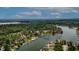 Expansive aerial view of waterfront homes surrounded by lush trees and blue water under a cloudy sky at 4161 S Summit Ln, Columbus, IN 47201