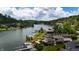 Picturesque aerial view of lakefront homes with private docks under a partly cloudy sky at 4161 S Summit Ln, Columbus, IN 47201