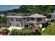 Exterior of home featuring large deck, patio, and backyard with mature trees at 4161 S Summit Ln, Columbus, IN 47201
