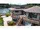 Exterior aerial view of a home featuring a large deck, surrounding trees, and lake access at 4161 S Summit Ln, Columbus, IN 47201