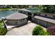 Lakefront home featuring a two-car garage, concrete patio, and well-manicured landscaping overlooking the water at 4161 S Summit Ln, Columbus, IN 47201