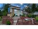 Back of home showing a patio, deck, and tiered backyard with mature landscaping at 4161 S Summit Ln, Columbus, IN 47201