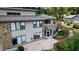Home's exterior showcasing a large patio, deck, and backyard nestled among lush trees at 4161 S Summit Ln, Columbus, IN 47201