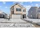 Attractive two-story home with a two-car garage and well-kept lawn in a friendly neighborhood, featuring a snowy yard at 5143 Rolling Meadow Blvd, Indianapolis, IN 46237