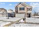 Inviting two-story home with a two-car garage, stylish exterior, and a pathway leading to the front door in snowy conditions at 5143 Rolling Meadow Blvd, Indianapolis, IN 46237