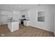 Modern kitchen featuring stainless steel appliances, ample white cabinets, and a spacious layout with light wood-look floors at 5143 Rolling Meadow Blvd, Indianapolis, IN 46237