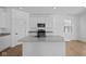 Stylish modern kitchen with an island, stainless steel appliances, light countertops, and ample cabinet space at 5143 Rolling Meadow Blvd, Indianapolis, IN 46237