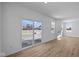 Living room features wood floors, large windows, and a glass sliding door at 5143 Rolling Meadow Blvd, Indianapolis, IN 46237