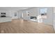 Open-concept living room featuring a linear fireplace, large windows, and modern light wood-look floors at 5143 Rolling Meadow Blvd, Indianapolis, IN 46237