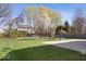 Expansive backyard with lush green grass, mature trees, and a basketball court for outdoor enjoyment at 6840 Minnow Dr, Indianapolis, IN 46237