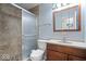 Bathroom featuring tiled shower, vanity with storage, and framed mirror for a practical yet stylish design at 6840 Minnow Dr, Indianapolis, IN 46237