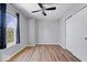 Inviting bedroom with a ceiling fan, closet, hardwood floors and a large window at 6840 Minnow Dr, Indianapolis, IN 46237