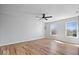 Bedroom features ceiling fan, hardwood floors and two windows offering natural light and a pleasant view at 6840 Minnow Dr, Indianapolis, IN 46237