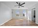 Bright bedroom features hardwood floors, ceiling fan, and two windows with lovely views at 6840 Minnow Dr, Indianapolis, IN 46237