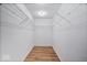 Spacious walk-in closet with wooden floors and wire shelving for optimal organization and storage at 6840 Minnow Dr, Indianapolis, IN 46237