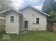 Back exterior of the home with two windows, a door, and a small yard at 237 Ringwood Way, Anderson, IN 46013