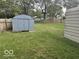 Large backyard features two storage sheds and a wooden fence at 237 Ringwood Way, Anderson, IN 46013